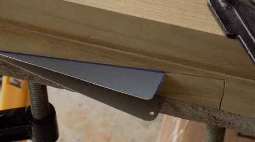 tab clamped in place with the carpet tape between the top piece of wood and the tab