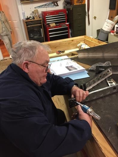 Dad pulls the very first rivet in the project.