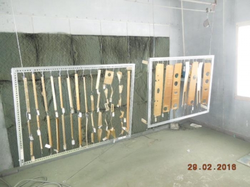 Parts hanging in the bodyshop paint booth