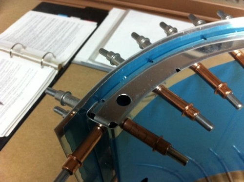 Door rib with enlarged hole for latch pin