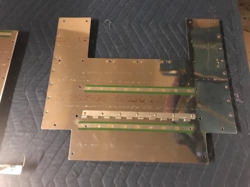 Forward floor skin with front seat hing riiveted to assembly