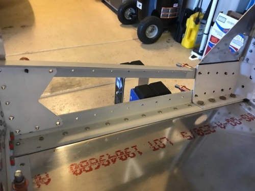 Lower longeron bolted and riveted to the floor assembly