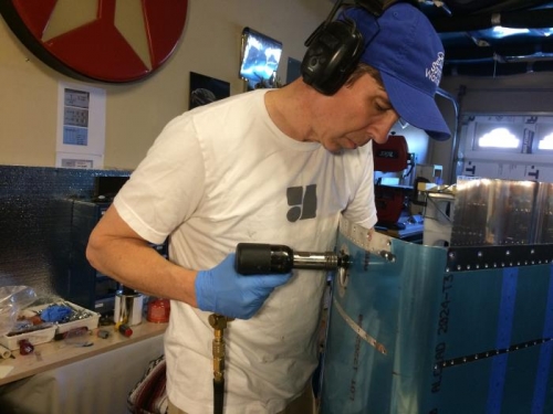 Riveting filler necks into place