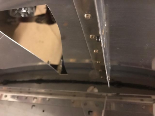 Inside view of the back of the firewall and the side skin next to air intake.  Showes the tank sealer