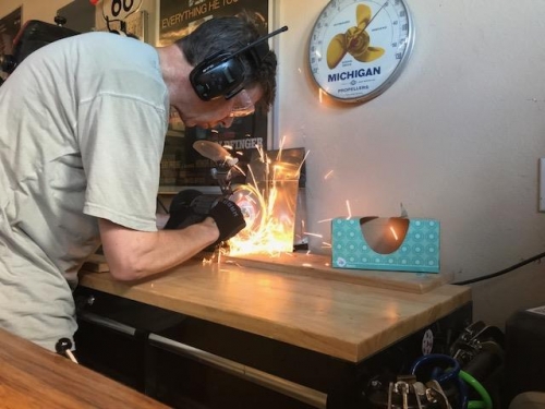 Grinding down a custom bucking bar for the rivets inside the wing spar roots
