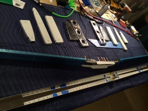 Front spar assembly with primed supports and primed ribs