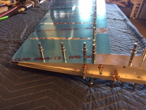 Skin and counterweight skin assembly to rib