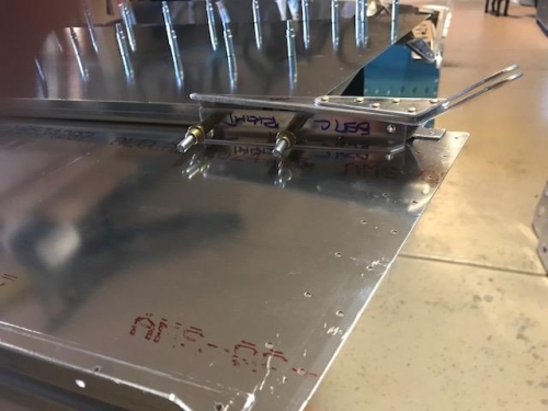 Seatbelt assembly clecoed to the lower longeron