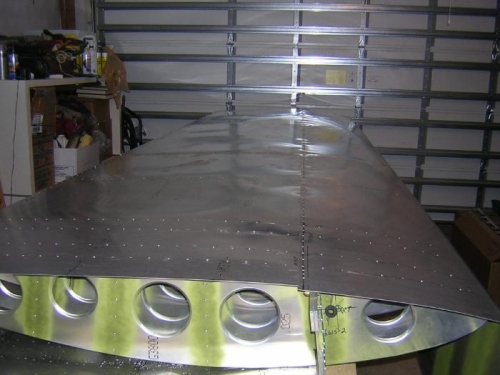 Bottom of one wing riveted