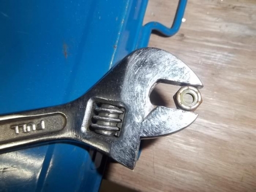 Small adjustable wrench helps locate nut inside channel