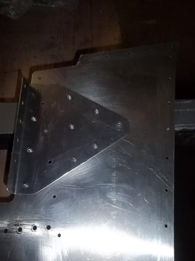 Torque channel side bracket partially riveted