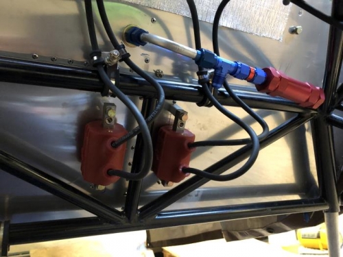 Spark plug wires secured to engine mount tubes