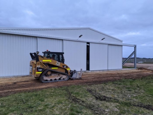 Smoothing out the dirt mounds at the front of the hangar