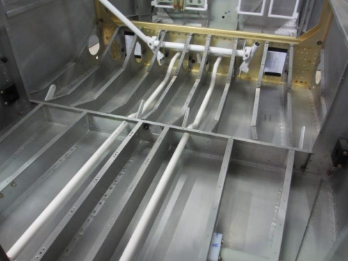 Two conduits running from the main spar, all the way back to behind the baggage compartment