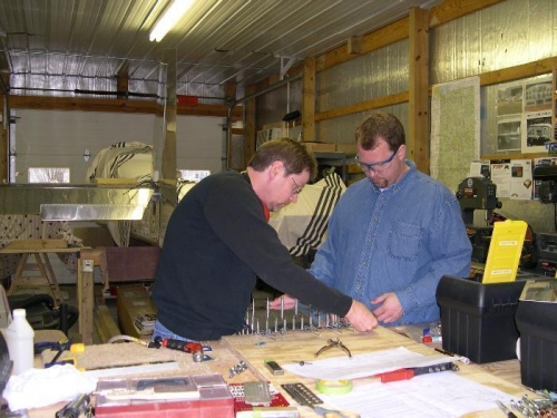 Troy giving Tom a hand, notice the RV-10 empennage in the background