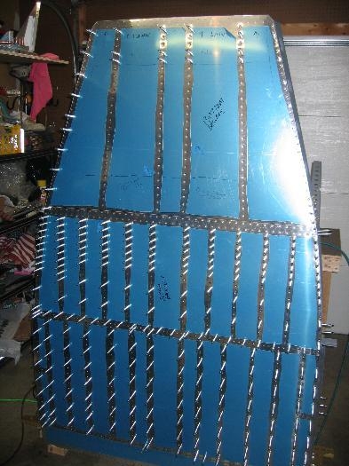 Baggage area skin riveted