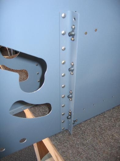 Attached angle riveted to forward fuselage ribs