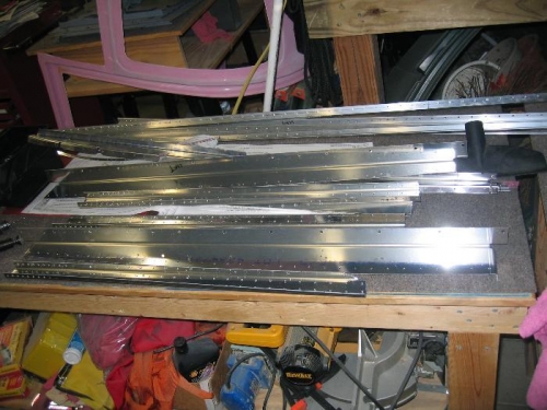 A stack of longerons and ribs waiting to be deburred, countersunk, and dimpled