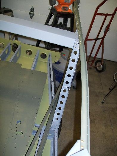 Left side of the seat back and longeron