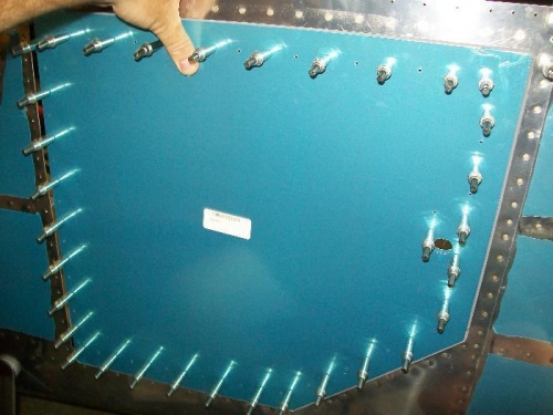 Baggage door held in its place on the fuselage