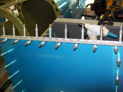 Baggage door hinge final drilled and clecoed