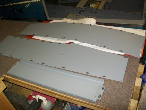 Side panel and tunnel cover nutplates riveted