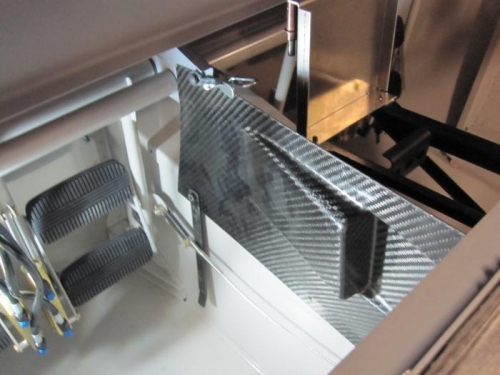 Holes drilled on the left lower console panel