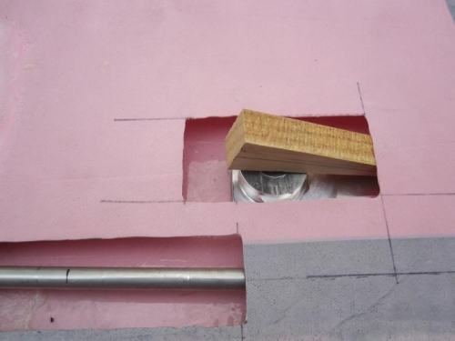 A wedge holding the flush handle in place until the expoxy dries