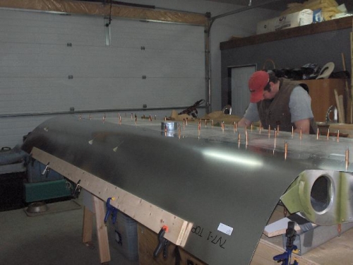 Wood on front is clamped on to stop any kinking of the skin