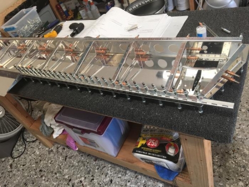 Fwd portion of the trim tab hinge match drilled and cleckoed into place. Excess hinge is trimmed away.