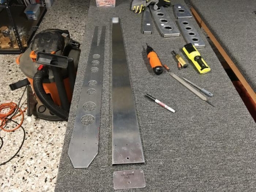 The three parts on the left are fully drilled, deburred and the thick doubler straightened.