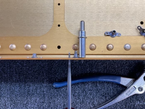 Lock the nutplate into position with a screw, cleco and final position with the awl