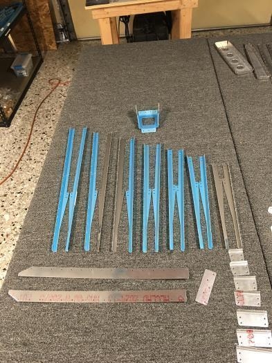 Trim and edge deburr various rudder parts.