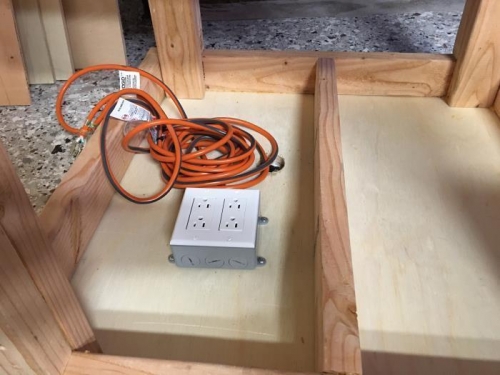 2-gang outlet box attached to the underside of the table.