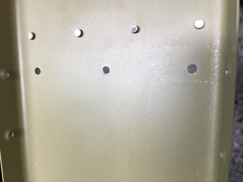 Right hole is oblong.  Middle hole has a partial countersink.