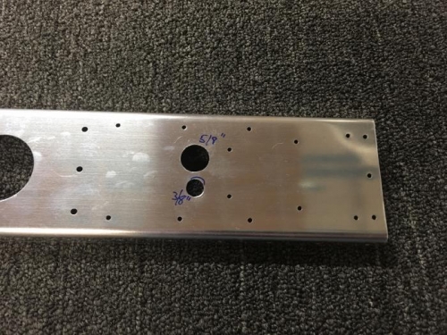 These are pass-through holes for the electric trim servo wiring. The large hole gets a snap bushing.