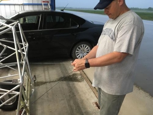 Jay marking center of rudder cable for cut