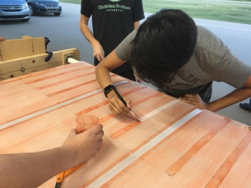 Dylan laying down a reinforcing tape on a false rib