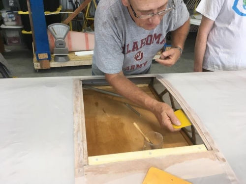 eric working on the cutout of the fabric for the right wing