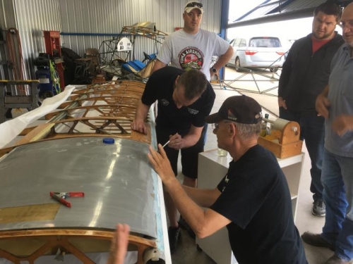 Eric and Bryan work on gluing the leading edge of the bottom left wing fabric