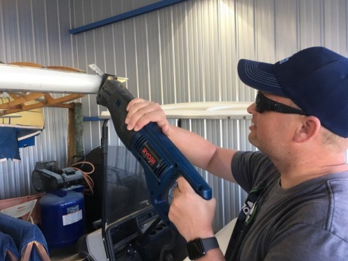 Jay using saw to cut off extra wingbay attachment ibeam