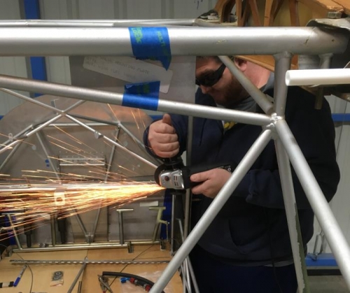 Derek grinds down tab where it interferes with the instrument panel