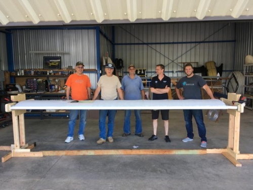 The crew put the wing on the 