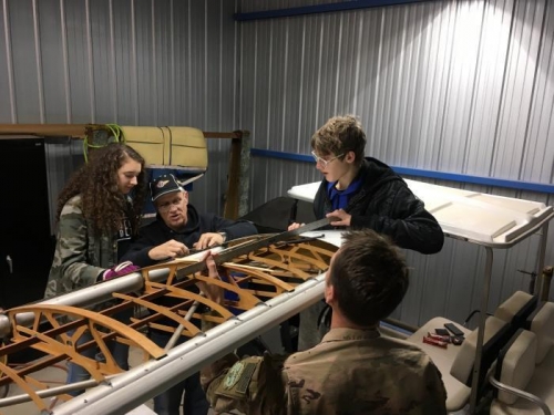 Eric shows Hannah how to align the trailing edge of the wingtip