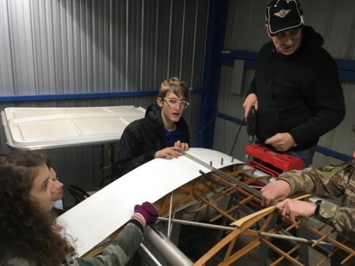 Jordan used a straighedge to align the wingtip while Ferenc holds it in position and Eric drills