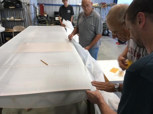 Jordan, Eric, Bryan, and Steve attaching leading edge, top fabric, right wing.