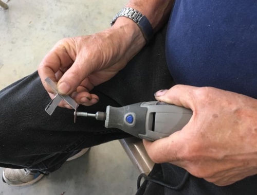 terry fabricates the rudder cable retainer strap from spare aluminum stock