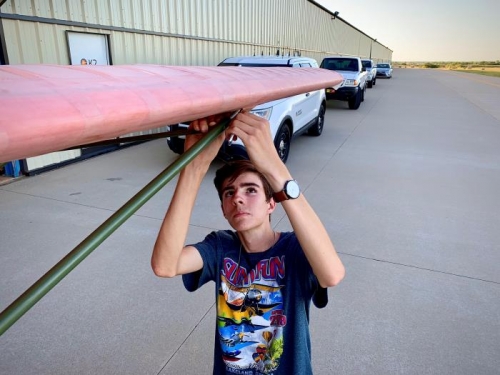 Lawson working to attach a wing strut bolt