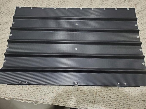 Lower half of the back baggage wall covered with carbon fiber wrap and with skybolts installedf