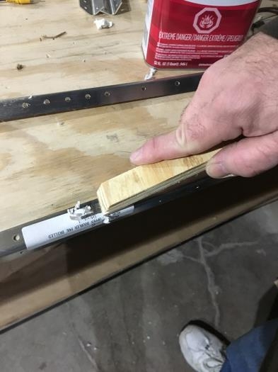 Removing label with a wooden edge.